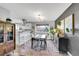Dining area adjacent to kitchen boasts modern light fixture and refinished cabinetry at 9749 Meade Cir, Westminster, CO 80031