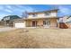 Inviting two-story home featuring a covered entryway, brick accents, and a well-maintained front lawn at 9749 Meade Cir, Westminster, CO 80031