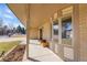 Covered front porch with brick detail, a bay window and ample space for seating at 9749 Meade Cir, Westminster, CO 80031