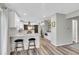 Open floor plan with island and bar stool seating, stainless steel appliances, and hardwood floors at 9749 Meade Cir, Westminster, CO 80031