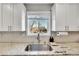 Kitchen sink with granite countertops and white cabinets at 9749 Meade Cir, Westminster, CO 80031