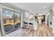 Bright kitchen with white cabinets, granite countertops, stainless steel appliances, and sliding glass door to backyard at 9749 Meade Cir, Westminster, CO 80031