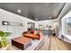 Bright living room features modern gray ceiling, decorative fireplace and wood look floors at 9749 Meade Cir, Westminster, CO 80031