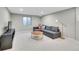 Bright living room boasts a comfy gray sectional, round coffee table, and natural light at 9749 Meade Cir, Westminster, CO 80031