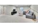 Spacious living room features modern gray sofa, wood coffee table, and large window at 9749 Meade Cir, Westminster, CO 80031