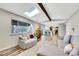 Open floor plan living room with a skylight and hardwood floors at 9749 Meade Cir, Westminster, CO 80031