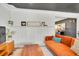 Cozy living room with wainscoting, wood floors, and orange sofa at 9749 Meade Cir, Westminster, CO 80031