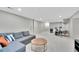 Open concept living room with gray sofa, modern furnishings, and entertainment area at 9749 Meade Cir, Westminster, CO 80031