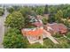 Overhead view of cozy stucco home with a red tile roof amid lush greenery at 1295 S Downing St, Denver, CO 80210