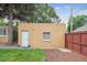 View of a single story building with a backyard and a red wooden fence at 1295 S Downing St, Denver, CO 80210