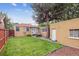 Expansive backyard with a patio, dining set, and lush green lawn at 1295 S Downing St, Denver, CO 80210