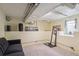 Cozy basement featuring a sofa, workout equipment, and window at 1295 S Downing St, Denver, CO 80210