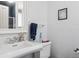Bright bathroom featuring a sink with vanity, a toilet, and a shower visible through the mirror's reflection at 1295 S Downing St, Denver, CO 80210
