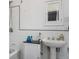 Clean white bathroom featuring a pedestal sink, tiled walls, and a bathtub with shower at 1295 S Downing St, Denver, CO 80210