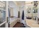 Luxurious bathroom with a soaking tub, mosaic tile accents, and a vanity with unique countertop sink at 1295 S Downing St, Denver, CO 80210