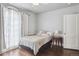 Bedroom with hardwood floors, natural light through sheer curtains, and a side table with a lamp at 1295 S Downing St, Denver, CO 80210