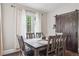 Dining room with natural light streaming through the windows, a rustic table, and sliding wood door at 1295 S Downing St, Denver, CO 80210