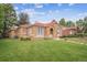 Charming stucco home with a red tile roof and a well-maintained lawn at 1295 S Downing St, Denver, CO 80210
