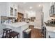Modern kitchen with white cabinets, quartz countertops, stainless steel appliances, and hardwood floors at 1295 S Downing St, Denver, CO 80210