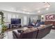 Well-lit living room featuring a large sectional, hardwood floors, and sliding door leading to the outside at 1295 S Downing St, Denver, CO 80210