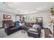 Comfortable living room showcasing hardwood floors, large sectional sofa, and bright natural light at 1295 S Downing St, Denver, CO 80210