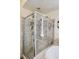 Corner shower with glass enclosure featuring tiled walls, a shower seat, and modern fixtures at 1295 S Downing St, Denver, CO 80210