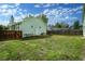Exterior view of the house with a large backyard, a wooden fence and a shed at 1391 Elmira St, Aurora, CO 80010