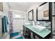 Bright bathroom featuring double sinks, modern fixtures, and a bathtub with a stylish shower curtain at 1391 Elmira St, Aurora, CO 80010