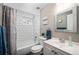 Bright bathroom featuring white subway tile, a shower-tub combination, and a vanity with a mirror at 1391 Elmira St, Aurora, CO 80010