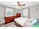 Cozy bedroom with neutral walls, a wooden dresser, and a ceiling fan at 1391 Elmira St, Aurora, CO 80010