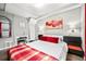 Stylish bedroom featuring a comfortable bed with bright accents, a functional desk, and ample lighting at 1391 Elmira St, Aurora, CO 80010