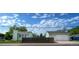 A home and detached garage are visible behind a wooden fence and chain link fence at 1391 Elmira St, Aurora, CO 80010