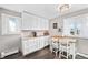 Well-lit kitchen featuring modern white cabinets, granite countertops, and a cozy breakfast bar at 1391 Elmira St, Aurora, CO 80010