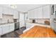 Updated kitchen featuring white cabinets, stainless steel appliances, and a cozy dining area at 1391 Elmira St, Aurora, CO 80010