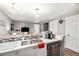 Open kitchen with bar seating, stainless steel appliances, and a seamless flow into the living area at 1391 Elmira St, Aurora, CO 80010