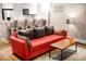 Relaxing living room showcasing a plush couch with soft pillows and an open view of the modern kitchen at 1391 Elmira St, Aurora, CO 80010