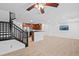 Open floor plan living area with staircase, kitchen view, and abundant natural light at 11935 Riverstone Cir # 6D, Henderson, CO 80640