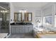 Spa-like bathroom with double vanity and soaking tub at 16355 Flintlock Ct, Parker, CO 80134