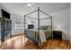 Main bedroom with a canopy bed and hardwood floors at 16355 Flintlock Ct, Parker, CO 80134