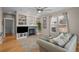 Bright living room with fireplace, built-in shelving, and hardwood floors at 16355 Flintlock Ct, Parker, CO 80134