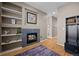 Living room with a fireplace and built-in shelving at 16355 Flintlock Ct, Parker, CO 80134