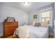 Cozy bedroom with wooden dresser and plush bedding at 2236 Jasmine St, Denver, CO 80207