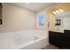 Bathroom with soaking tub and dark brown vanity at 3272 Brushwood Dr, Castle Rock, CO 80109