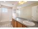 Bathroom with single vanity, tub, and window at 3272 Brushwood Dr, Castle Rock, CO 80109