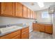 Laundry room with wooden cabinets and window at 3272 Brushwood Dr, Castle Rock, CO 80109