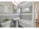 The bathroom features neutral colors and a shower and tub with a shower curtain at 2801 Gray St, Wheat Ridge, CO 80214