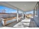 Covered patio with white pillars, concrete floors and space for outdoor entertaining and gardening at 2801 Gray St, Wheat Ridge, CO 80214