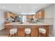 Bright kitchen featuring a large countertop island with seating, modern appliances, and ample cabinet space at 2801 Gray St, Wheat Ridge, CO 80214