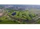 Beautiful aerial view of golf course and surrounding parkland with lakes, trees, and bridges at 7615 E Quincy Ave # 103, Denver, CO 80237