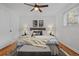 Comfortable bedroom features two bedside tables, trendy artwork, and a ceiling fan at 7615 E Quincy Ave # 103, Denver, CO 80237